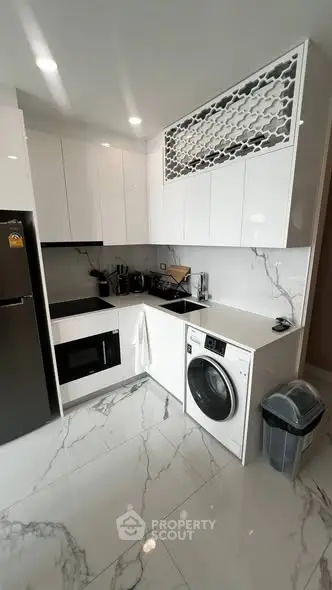 Modern kitchen with sleek white cabinets and built-in appliances