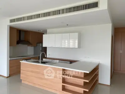 Modern kitchen with sleek wooden cabinetry and island in open layout apartment