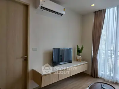Modern living room with sleek TV setup and large window view