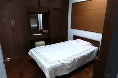 Cozy bedroom with wooden furniture and built-in wardrobe
