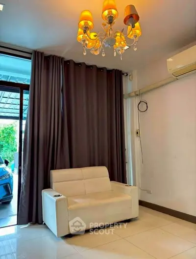 Cozy living room with elegant chandelier and modern sofa