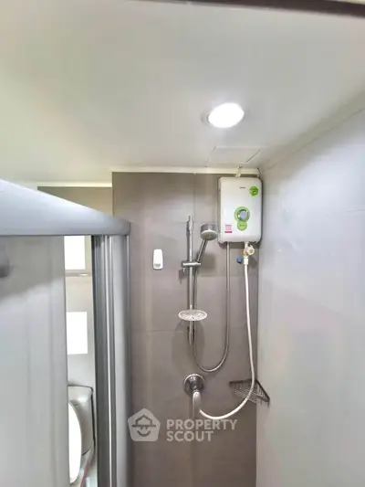 Compact bathroom with modern shower and water heater