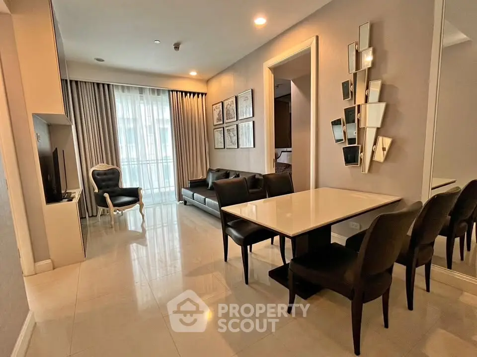 Elegant living and dining area with modern decor and ample natural light.
