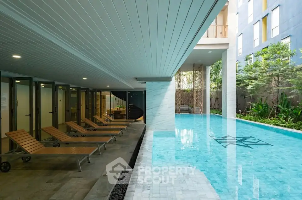 Luxurious indoor pool area with modern design and relaxing lounge chairs