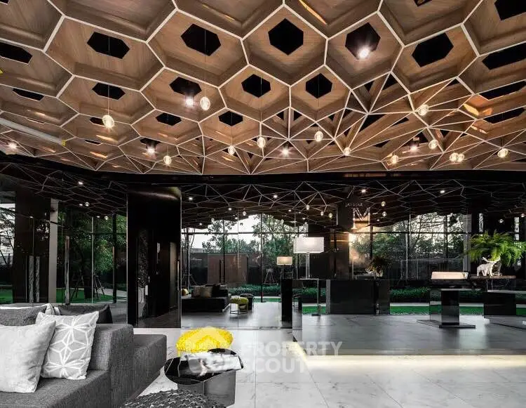 Luxurious modern living room with unique geometric ceiling design and expansive garden view.