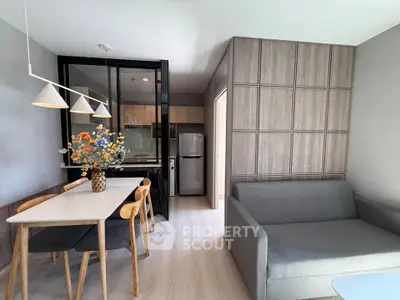 Modern living room with sleek kitchen and stylish dining area