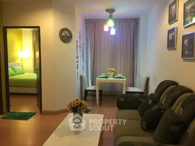 Cozy living room with elegant decor and adjacent dining area in modern apartment.