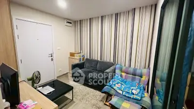 Cozy living room with modern decor and striped accent wall, perfect for relaxation.