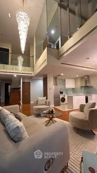 Luxurious modern living room with high ceilings and elegant chandelier