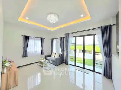 Spacious living room with modern decor and large windows offering scenic views.