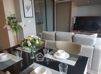Modern living room with elegant dining setup and cozy sofa, perfect for stylish urban living.