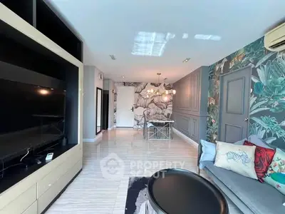 Stylish living room with modern decor and large TV unit, perfect for relaxation and entertainment.