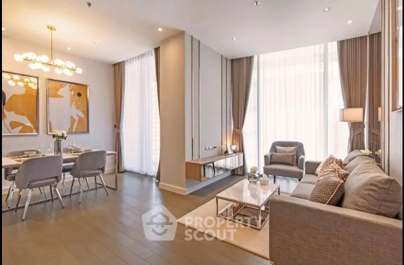 Elegant modern living room with dining area, featuring floor-to-ceiling windows and stylish decor.