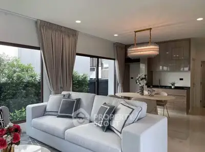 Luxurious living room with elegant decor and open kitchen layout, perfect for modern living.