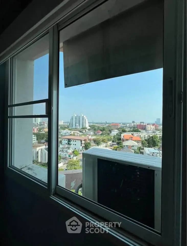 Stunning cityscape view from a high-rise apartment window, showcasing urban living at its finest.