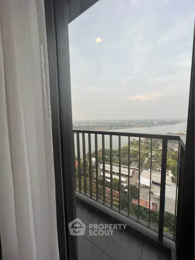 Stunning high-rise balcony with panoramic city and river view.