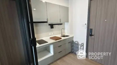 Modern compact kitchen with sleek cabinetry and built-in appliances