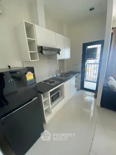 Modern kitchen with sleek appliances and open layout in stylish apartment