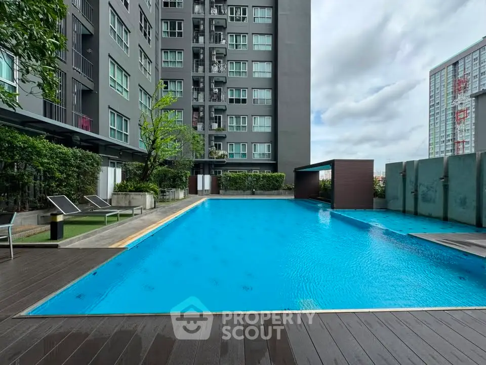 Luxurious apartment complex with stunning outdoor pool and modern amenities.