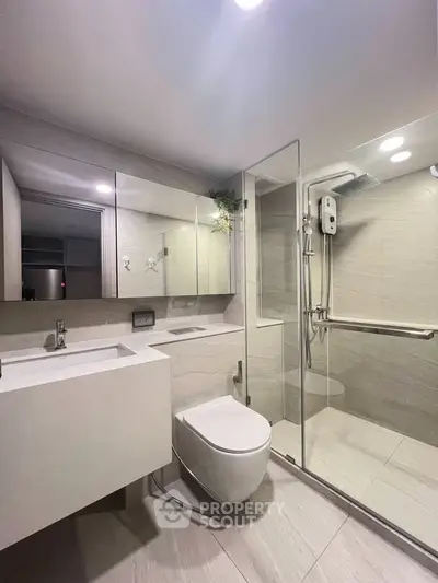Modern bathroom with sleek design, glass shower enclosure, and contemporary fixtures.
