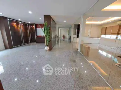 Spacious modern living room with glossy floors and glass partitions