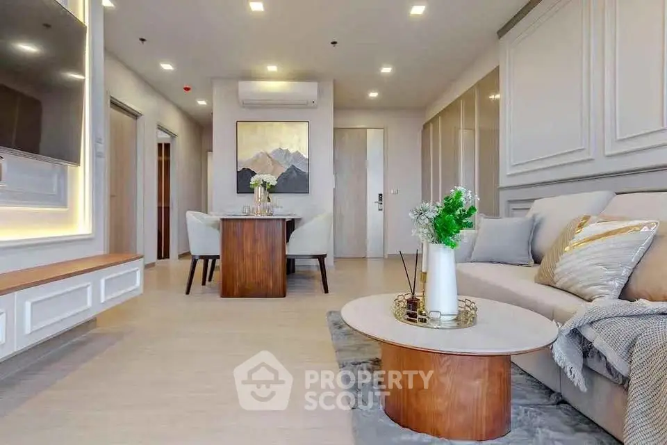 Modern living room with elegant decor and open layout, featuring stylish furniture and ambient lighting.