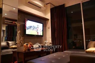Luxurious living room with modern decor and city view, featuring a sleek leather sofa and wall-mounted TV.