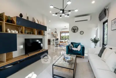 Modern living room with stylish furniture and open layout, featuring a sleek TV unit and elegant decor.