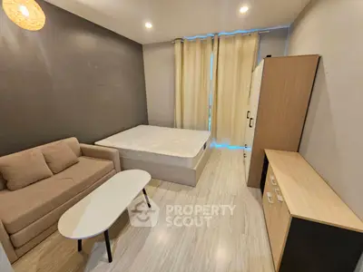 Modern bedroom with cozy sofa and stylish furniture, perfect for urban living.