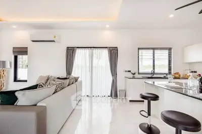 Modern open-plan living room with sleek kitchen and stylish decor