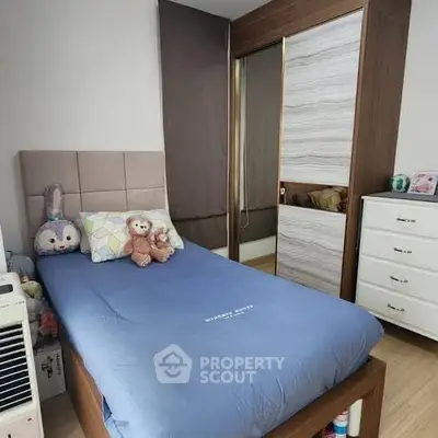 Cozy bedroom with plush toys and modern wardrobe, perfect for a child's retreat.