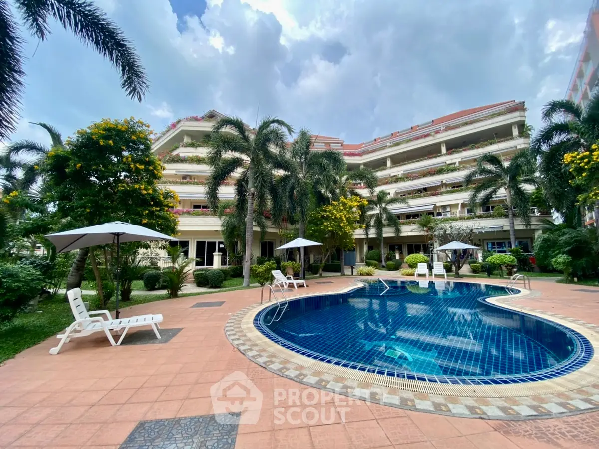 Luxurious apartment complex with a stunning pool and lush gardens, perfect for relaxation and leisure.