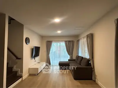 Spacious living room with modern decor and large windows for natural light.