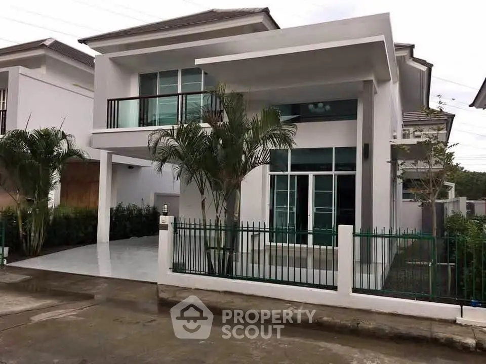 Modern two-story house with sleek design and spacious driveway in a serene neighborhood.
