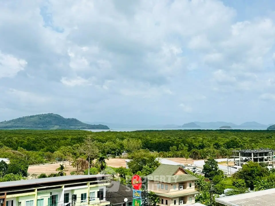 Scenic view of lush greenery and distant mountains from a high vantage point, ideal for nature lovers.