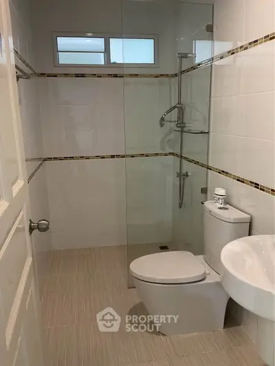 Modern bathroom with glass shower enclosure and sleek fixtures