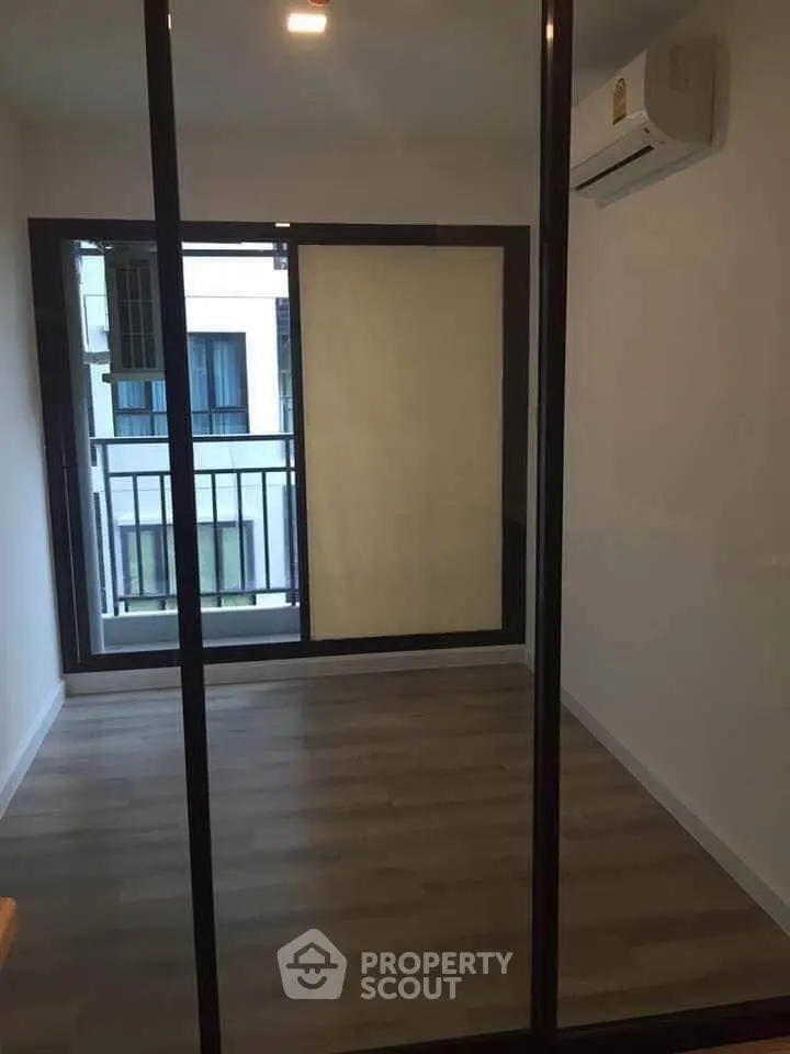 Modern empty room with glass sliding doors and air conditioning unit