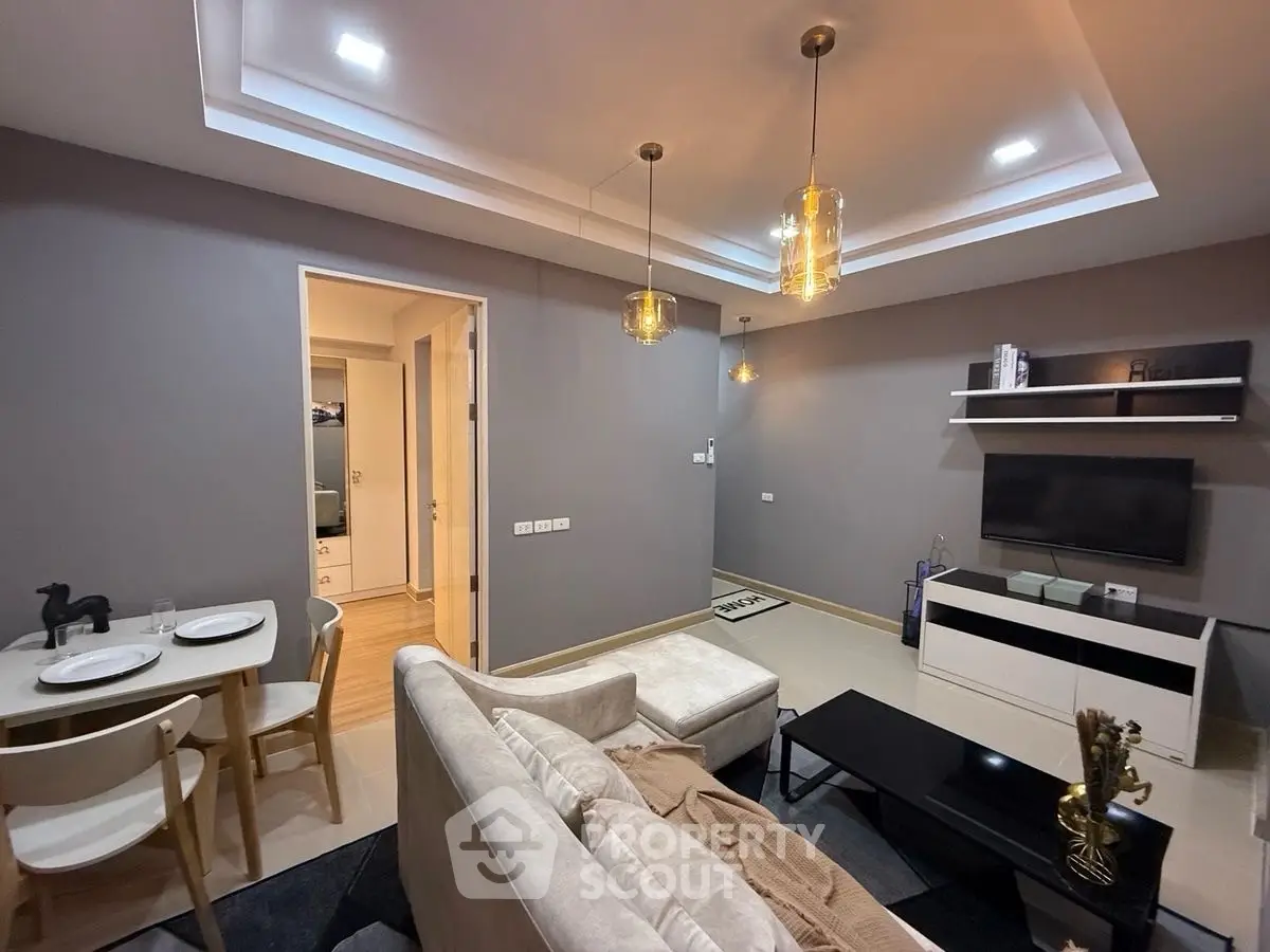 Modern living room with stylish lighting and cozy seating area in a contemporary apartment.