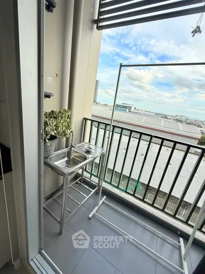 Charming balcony with a sink and stunning city view, perfect for urban living.