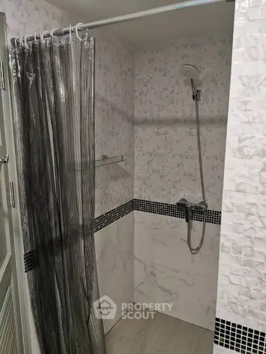 Elegant bathroom with modern shower, stylish tiling, and sleek fixtures, perfect for a refreshing start to the day.
