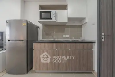 Modern kitchen with sleek cabinetry and stainless steel appliances in a compact layout.