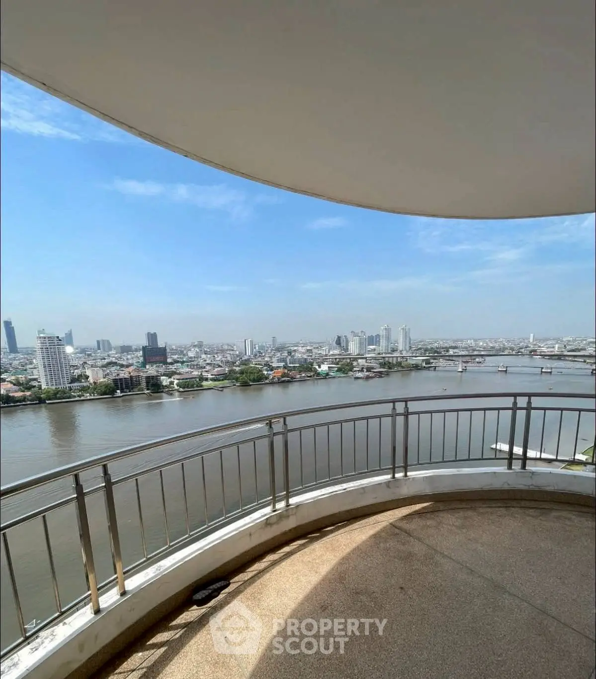 Stunning river view from a high-rise balcony in a modern cityscape.