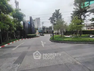 Spacious urban entrance with lush greenery and modern design, ideal for upscale living.
