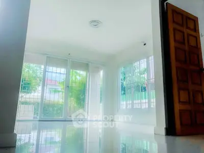 Bright and spacious living room with large windows and garden view