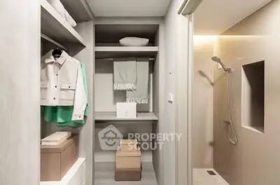 Modern storage room with built-in shelves and shower area
