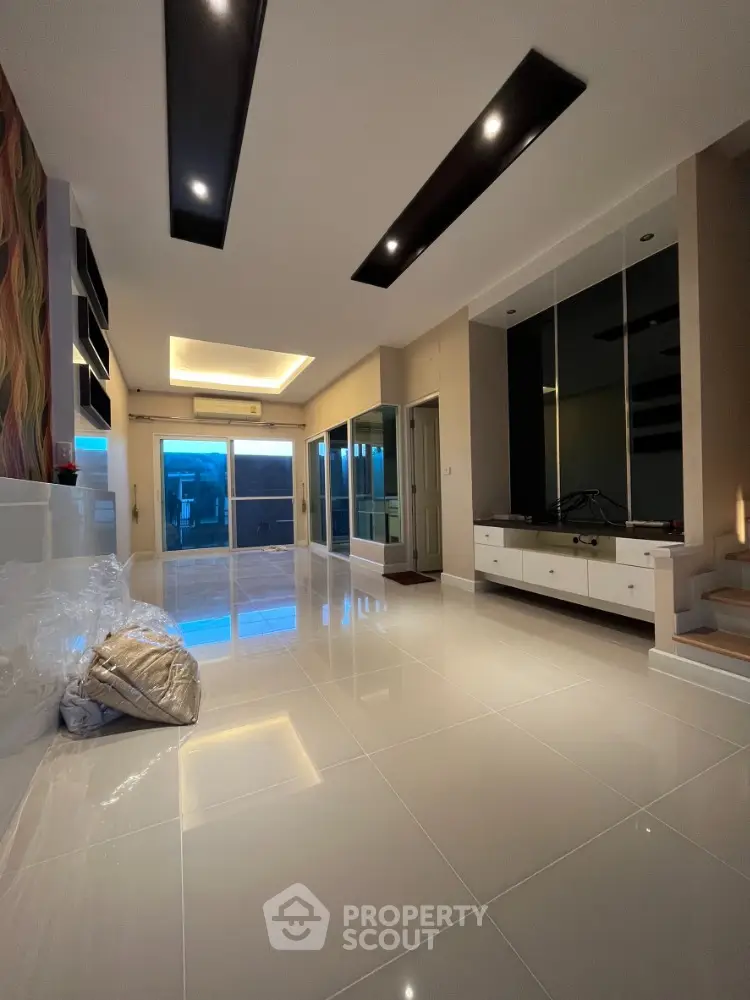 Spacious modern living room with sleek design and large windows