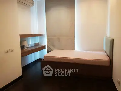 Cozy bedroom with single bed and modern wooden furniture, perfect for a minimalist lifestyle.