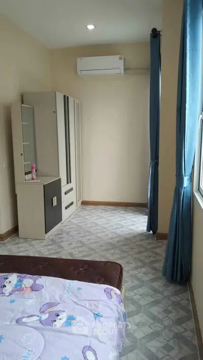 Cozy bedroom with air conditioning and modern wardrobe, perfect for comfortable living.