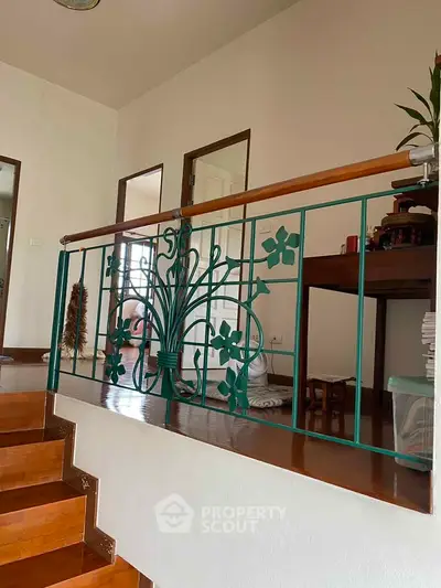 Charming interior staircase with decorative railing in a cozy home setting.