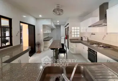 Spacious modern kitchen with sleek countertops and built-in appliances, perfect for culinary enthusiasts.